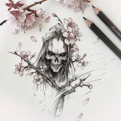 a pencil drawing of a skull with flowers on it's head and two pens next to it