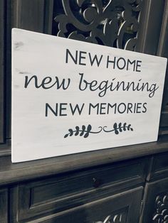 a sign that is on the side of a door saying new home, new beginning and new memories