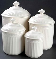 three white kitchen canisters with lids