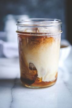 a jar filled with liquid sitting on top of a table