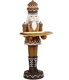 a nutcracker holding a tray with food on it