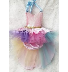 Rainbow Dreams Romper The perfect outfit for any little Princess. This magical piece is inspired by rainbows and unicorns. With magical Patel colors and a Beautiful high low double skirt. Custom colors welcomed to match any theme. Custom sizes available. Handmade to order Pink Playful Tutu Dress With Unicorn Print, Pink Playful Unicorn Print Tutu Dress, Playful Pink Tutu Dress With Unicorn Print, Rainbow Unicorn Print Tutu Dress For Party, Multicolor Unicorn Print Tutu Dress For Party, Rainbow Playful Tutu Dress For Dress-up, Playful Rainbow Tutu Dress For Dress-up, Multicolor Princess Tutu Dress For Costume, Princess Style Multicolor Tutu Costume Dress