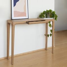 a wooden table with a plant on top