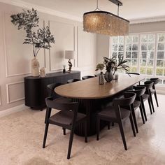 a dining room table with chairs and a chandelier