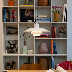 a book shelf filled with books and vases