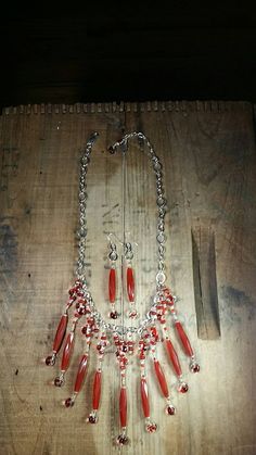 The rich in color Carnelian beads in this design are fabulous. They're such a unique style of bead and in combination with the hand blown Artisan Glass beads they create a true one of a kind design. This is absolutely a statement bib piece that includes matching earrings. **Talk about a bright silver & red kind of statement bib necklace. Pop this baby on just about any outfit and you'll been seen even in the largest group of people! This bright silver chain necklace is shy of 18'' long before the sterling lobster clasp and 2'' extender chain. One of the beauty's of this piece is you can wear it closer to your neck or as a choker if you want because of the lobster clasp and room in the chains links are easy to clip it into.   * **Made up with 9 fabulous, long, rich in color... faceted Carne Beaded Agate Dangle Jewelry, Agate Beaded Dangle Jewelry, Red Carnelian Round Bead Jewelry, Elegant Red Agate Necklace, Oval Glass Gemstone Beads Jewelry, Red Beaded Agate Jewelry, Red Coral Round Beads For Jewelry Making, Red Agate Beaded Jewelry, Artisan Dangle Jewelry With Polished Beads