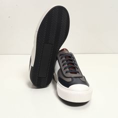 This leather lace up sneaker has been handcrafted from flawless grain leather, embellished with a leather insole that nods to the brand's heritage. Perfectly paired with tailored suits and leather jackets. Leather Lining for a luxurious feel and moisture control Leather collar and tongue Rubber sole Tapered round toe. The handmade sustainable Gommus rubber outsole and insole are Made in Italy. STYLE #D2168T Modern Low-top Lace-up Shoes With Leather Sole, Modern Low-top Leather Shoes For Streetwear, Sporty Navy Leather Sneakers, Navy Leather Sporty Sneakers, Sporty Navy Sneakers With Leather Sole, Low-top Leather Shoes With Rubber Sole For Streetwear, Modern Navy Sneakers With Round Toe, Low-top Leather Shoes With Stitched Sole For Streetwear, Custom Low-top Sneakers With Leather Sole