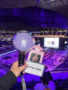 a person holding up an award in front of a crowd at a concert or show