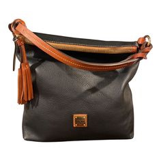 This Beautiful Dooney And Bourke Pebble Leather Hobo Will Sure Compliment Your Classy And Sophisticated Style. Knotted Handle Leather Tassels Black With Brown Leather Trim Very Clean In And Out Few Scuffs/Scratches (Please See Last 3 Photos ) 13 1:2 Length 13/1/2 Width 5 Inch Dimension Many Compartments In The Interior A Beautiful Investment Piece To A Stylish Wardrobe Stylish Wardrobe, Dooney And Bourke, Dooney & Bourke Bags, Dooney & Bourke, Leather Tassel, Leather Hobo, Sophisticated Style, Leather Trim, Dooney Bourke