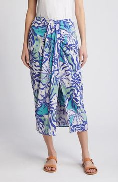 Vacation vibes run strong in this vibrant skirt shaped by graceful draping and cut from breezy cotton in a celestial print. 31" length Back elastic waist 100% cotton Machine wash, tumble dry Imported Blue Floral Print Maxi Skirt For The Beach, Blue Gathered Beach Skirt, Blue Gathered Skirt Bottoms For Vacation, Beachwear Floral Print Flowy Skirt, Floral Print Flowy Beachwear Skirt, Flowy Floral Print Skirt For Beachwear, Fitted Blue Wrap Skirt For Beach, Fitted Blue Wrap Skirt For The Beach, Beach Asymmetrical Skirt With Floral Print