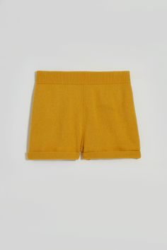 Hello, Jasper. Our comfy knitted shorts. These fun shorts are lightweight and cozy, with a rolled hem that includes an added link stitch detail. Easy and stylish, Jasper comes with a practical elasticated waistband and sports two handy side pockets. Jasper is composed of 100% recycled fibers, and is GRS certified. Both the fibers and the manufacturing are made in ITALY to lower our carbon footprint. Unisex. Fun Shorts, Knitted Shorts, Rolled Hem, Carbon Footprint, Knit Shorts, Gold Yellow, Italy, Knitting, Yellow