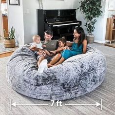 a family sitting on a bean bag chair in their living room