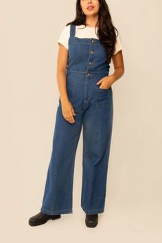 Crafted from organic cotton dark denim, our Grace Jumpsuit is the perfect transitional piece. Featuring overalls with front and back patch pockets, as well as a four-button front closure and high waist, the jumpsuit flows into wide-leg pants for an ankle-grazing length. Adorned with undeniable charm yet ultra-comfortable, this classic wardrobe staple is great for layering. We updated the fit from previous production, so it's trueu00a0to size! Content + Care \-100% Organic Cotton \-For best resul Classic Wardrobe Staples, Classic Wardrobe, Denim Jumpsuit, Dark Denim, Leg Pants, Wide Leg Pants, The Row, Urban Outfitters, Layering