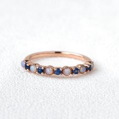 Blue Sapphire & Opal Rose Gold Ring Opal Rose Gold Ring, Silly Wedding, Blue Sapphire Wedding Band, Opal Wedding Band, Gold Wedding Bands Women, Rose Gold Opal Ring, Band Ideas, Sapphire Wedding Rings, Gold Anniversary Rings