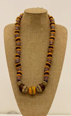 Indulge in the timeless beauty of our handcrafted African Krobo bead necklace. This stunning piece features a captivating blend of caramel Krobo powder glass beads, Ghana brass bead caps, round dark brown translucent Krobo powder glass beads, and dusk beads. Key Features: Eye-Catching Design: The rich caramel and dark brown hues create a visually stunning and versatile necklace. High-Quality Materials: Crafted with durable glass beads and brass components. Adjustable Length: The 20.5-inch length allows for a comfortable Ξt. Ethical and Fair Trade: Support sustainable and ethical practices with this handcrafted necklace. Add a touch of global Οair to your wardrobe and make a statement with our Caramel Krobo Bead Necklace. Order yours today! 13 META TAGS : Affordable Traditional Beaded Necklaces With Large Beads, Luxury Brown Beaded Necklaces With Round Beads, Pumtek Beads Necklace, Kenyan Necklaces, Krobo Beads, African Beads Necklace, Glass Beads Necklace, Necklace African, African Necklace