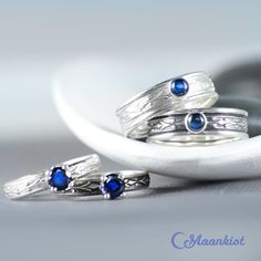 "These Blue Sapphire Couple Rings make a striking pairing! The wide band ring features a 4 mm cabochon securely set in a fine silver bezel. The narrow band ring features a 5 mm faceted stone set in a filigree prong mounting. We are happy to create this beautiful set for you in a variety of gemstone choices, size options, and finishes. For the Wide Ring: This ring features a 4 mm cabochon set on a Sterling Silver band. The band measures 6 mm wide (about .25\"). The Art Deco inspired design extend Sapphire Jewelry With Tension Setting, Concave Gemstone Rings As Gift, Fusion Style Stackable Anniversary Rings, Anniversary Fusion Style Stackable Round Rings, Fusion Style Stackable Round Rings As A Gift, Sapphire Rings With Tension Setting For Gift, Sapphire Jewelry With Tension Setting For Promise, Wide Band Jewelry With Tension Setting As A Gift, Wide Band Jewelry With Tension Setting For Gift