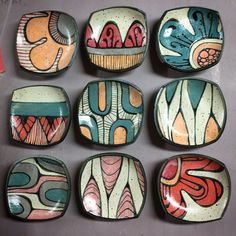 nine handmade ceramic bowls with designs on them