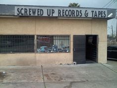 the front of a building that has been boarded up records and tapes