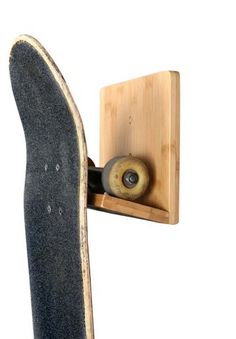 a skateboard mounted to the side of a wooden board holder with wheels on it