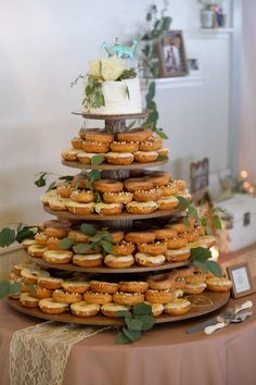 a wedding cake made out of doughnuts on a table