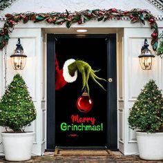 the grinch door cover is decorated with christmas trees and presents on it's front porch