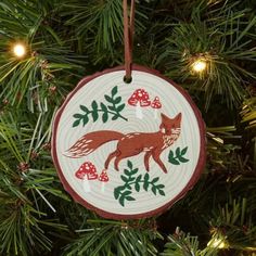 a red fox ornament hanging from a christmas tree