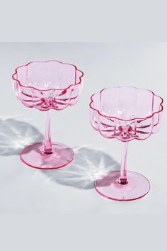 two pink glass dishes sitting on top of each other