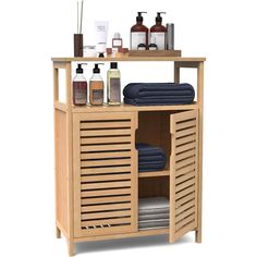 a wooden cabinet with towels, soaps and other personal care items on top of it