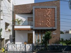 a brick building with a white fence around it