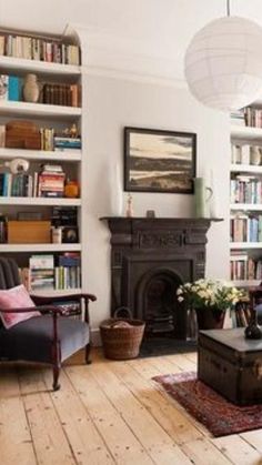 a living room filled with furniture and bookshelves