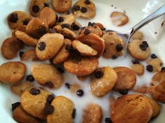 a bowl filled with chocolate chip cookies and milk