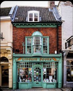 an old building with green doors and windows