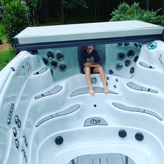 a man sitting in the middle of a hot tub