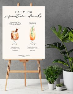 an easel with a sign that says bar menu and two cocktails on it