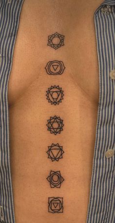 the seven chakras tattoo on the back of a man's chest is shown