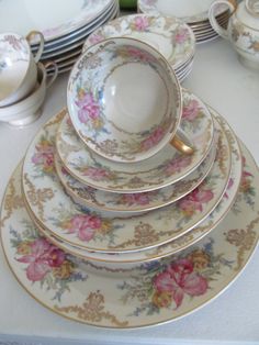 a table topped with plates and cups filled with saucer's on top of each other