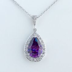 Luxury purple amethyst cubic zirconia bridal tear drop dangle pendant and necklace in rhodium plated brass setting. Necklace pendant features a large teardrop with pear cut purple ametyst cubic zirconia center surrounded by tiny round zirconia crystals. and dangles from cubic zirconia bail. Length of the rhodium plated chain is 18 inches and comes with 2 inches extender and lobster clasp. For matching earrings click: https://www.etsy.com/listing/398372301/purple-amethyst-wedding-crystal-earrings Purple Sparkling Stone Necklaces For Wedding, Purple Sparkling Stones Necklace For Wedding, Purple Cubic Zirconia Necklaces For Anniversary, Purple Cubic Zirconia Necklace For Anniversary, Teardrop Amethyst Necklace For Formal Occasions, Formal Teardrop Amethyst Necklace, Purple Drop Necklace For Formal Occasions, Formal Amethyst Drop Necklace, Formal Drop Amethyst Necklaces