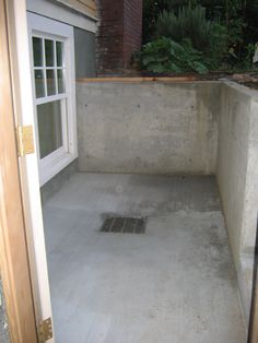 an open door leading to a room with concrete flooring