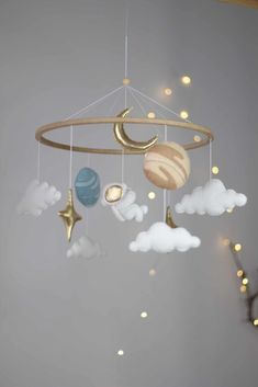 a mobile with planets and stars hanging from it