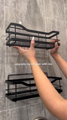 a woman is holding up a shelf in the shower