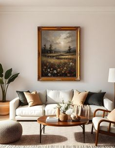 a living room filled with furniture and a painting on the wall