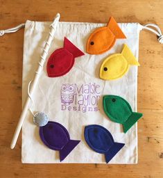 a white bag with felt fish on it