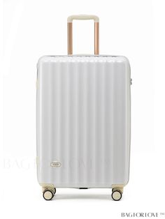 a white suitcase with gold handles on wheels and handlebars in front of a white background