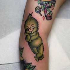 a tattoo on the leg of a person with a bear and hot air balloon in the background