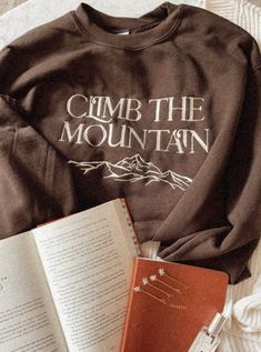 Climb the Mountain Embroidered Crewneck Sweatshirt – House of Jupiter Climb The Mountain Acotar, Outdoorsy Sweatshirt, Climb The Mountain, Mountain Style, Cute Shirt Designs, Embroidered Crewneck, Embroidery Ideas, Cute Shirts, Piece Of Clothing