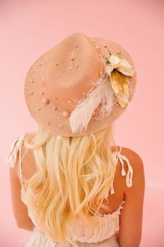 Shade yourself in unique style with the GOLDEN FLOWERS SUN HAT. This golden hat features elegant pearls, chic gold and cream feathers, delicate white flowers, and a playful horseshoe pin. Perfect for any Derby event or to simply add a touch of glamour to your look! This hat is ONE OF A KIND, created by our owner Stephanie. To receive item quicker, expedited shipping is available at checkout.