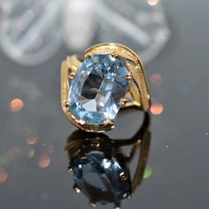 A ladies 14 karat yellow gold leaf design ring set with an oval cut blue topaz.  The ring is size 5.75 Gold Leaf Design, Rose Gold Morganite, Shiny Objects, Diamond Anniversary Rings, Easily Distracted, Diamond Anniversary, The Ring, Leaf Design, Estate Jewelry