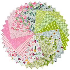 a bunch of different colored papers on top of each other with flowers and polka dots