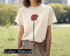 Elevate your style with our Aesthetic Retro Rose Head T-Shirt. This design features a beautifully detailed rose head in a classic retro style, with its vibrant petals and intricate lines capturing timeless beauty. The saying "Bloom with grace like a rose" is elegantly woven into the stem, adding a touch of inspirational flair. Printed on high-quality 100% cotton Bella Canvas 3001 (heather colors includes polyester), this t-shirt offers unbeatable comfort and durability. Whether you're dressing u Aesthetic Red Rose, Bloom With Grace, Aesthetic Roses, Women Aesthetic, Aesthetic Retro, Aesthetic Red, Flower Shirt, Retro Stil, Shirt For Women