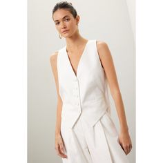 Off-white cotton-linen blend (54% Cotton, 46% Linen) with acetate-viscose lining (74% Acetate, 26% Viscose). Jacket. Sleeveless. Front button closure. 16.5" from shoulder to hemline. Imported. Elegant Spring Tops With Notch Lapel, Elegant Notch Lapel Tops For Spring, Tailored Linen Spring Vest, Tailored Linen Vest For Spring, Chic Formal Summer Vest, Spring Formal Linen Vest, Tailored Linen Vest For Summer, White Spring Vest For Daywear, Elegant Tailored Vest For Summer